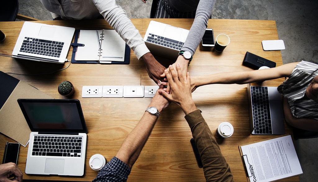 Team of business people stacking hands